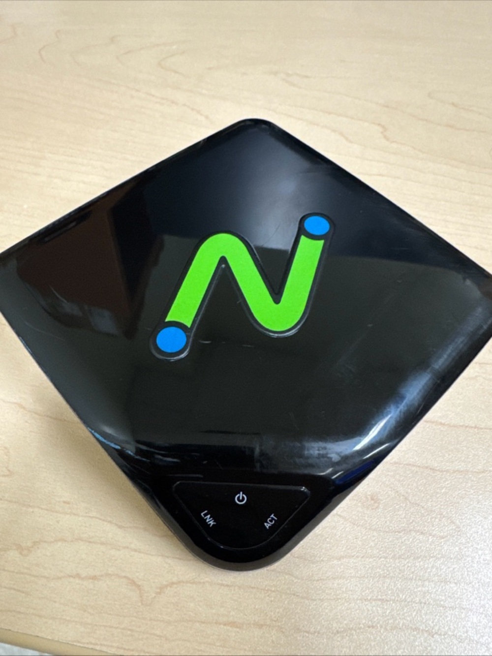 Glossy Black Network Device with Bright Green 'N' Accent